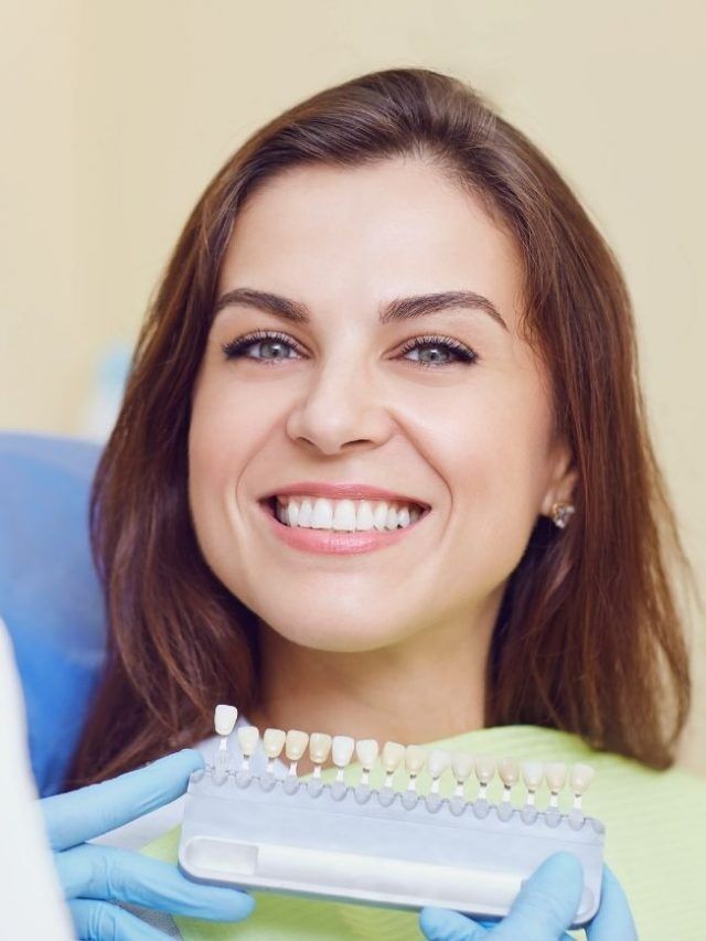 Smiling woman patient next to a dentist