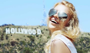 woman smiling before hollywood sign