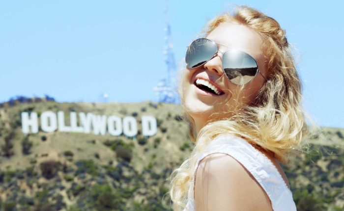 woman smiling before hollywood sign