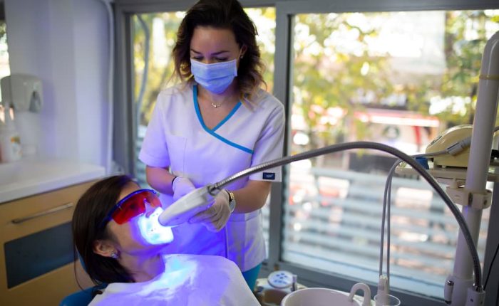woman bleaching teeth with dental laser